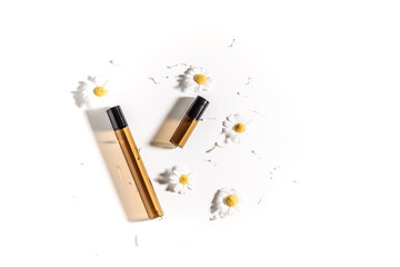 Container with chamomiles. Herbal dermatology cosmetic hygienic cream. Natural beauty product. Face cream with flowers of chamomile. Cosmetics.