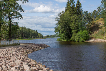 Beautiful landscape-Vyborg Bay with green trees and grass on the winding shores on a sunny summer day in the Monrepos Park in Russia