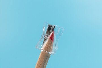 Close up view of a pencil being sharpened in a transparent pencil sharpener