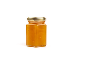 Glass jar full of sweet honey isolated on white background
