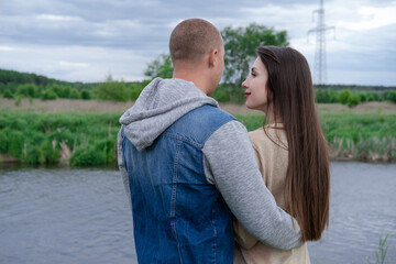Fototapeta premium fashionable young couple outdoors. bald man and brunette woman. husband and wife. millennials in trendy clothes - jeans.