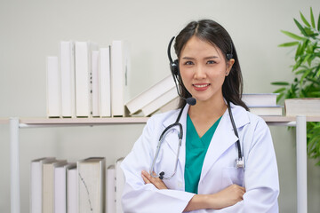 Asian smiling female doctor waers headset and stethoscope for healthcare online call center concept