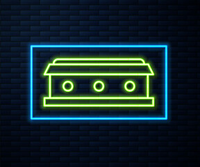 Glowing neon line Coffin with christian cross icon isolated on brick wall background. Happy Halloween party. Vector