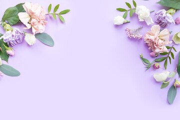 Floral frame with pink roses, white flowers, branches, leaves and petals on violet background. Flat lay, top view