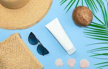 top view. sunscreen on blue background. relax on the beach concept.