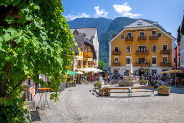 Hallstatt, Austria - July 31, 2021 - A scenic picture postcard view of the famous town square in the village of Hallstatt in the Austrian Alps. - obrazy, fototapety, plakaty