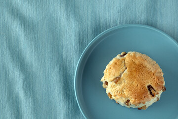 Top view at british scone on a plate blue color, flat lay