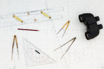 Navigation tools are on the navigation map. Plotter, divider, ruler, binoculars and pencil.