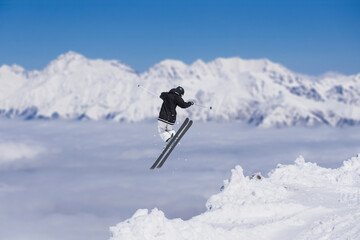 Cloudy mountain landscape with flying skier, Russia
