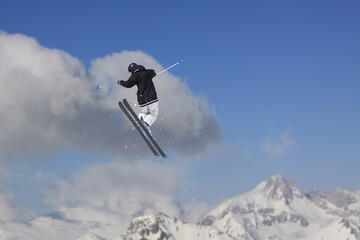 Naklejka na ściany i meble Cloudy mountain landscape with flying skier, Russia