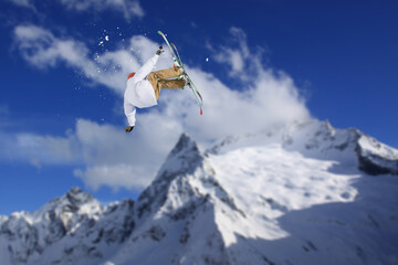 Naklejka na ściany i meble Cloudy mountain landscape with flying skier, Russia