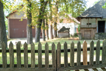 wooden fence with blurred buildings in background
