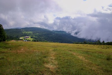 Obraz premium A view to the landscape with forests and hotel covered by clouds near Brennes, Germany