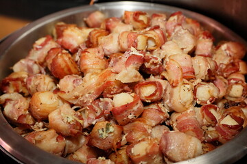 Bacon-wrapped chicken meat in bowl at party