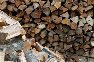 Wood pile reserve for the winter. Pile of chopped firewood. Background texture wood. Wood chips
