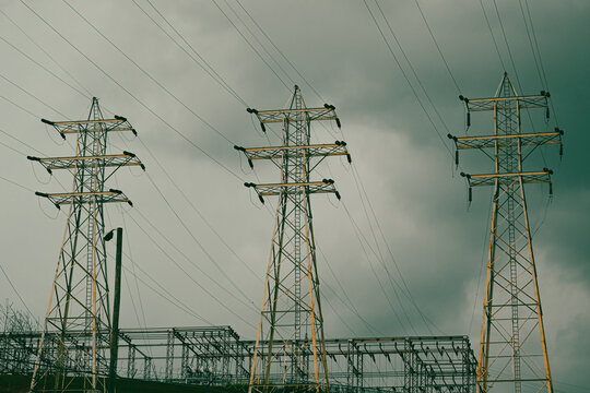 High Tension Power Lines With Bruised, Storm Clouds And Dramatic Sky