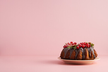 Christmas cake at pink background.