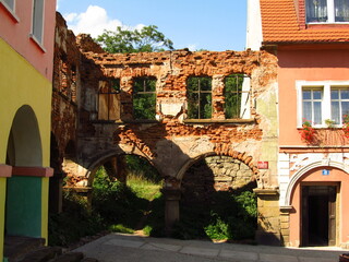Stara ceglana ściana pomiędzy odnowionych kamienic, Polska 