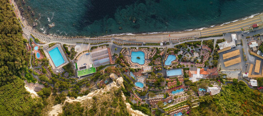 Overhead aerial view of Ischia Citara Beach at sunset with pools and sand. - obrazy, fototapety, plakaty