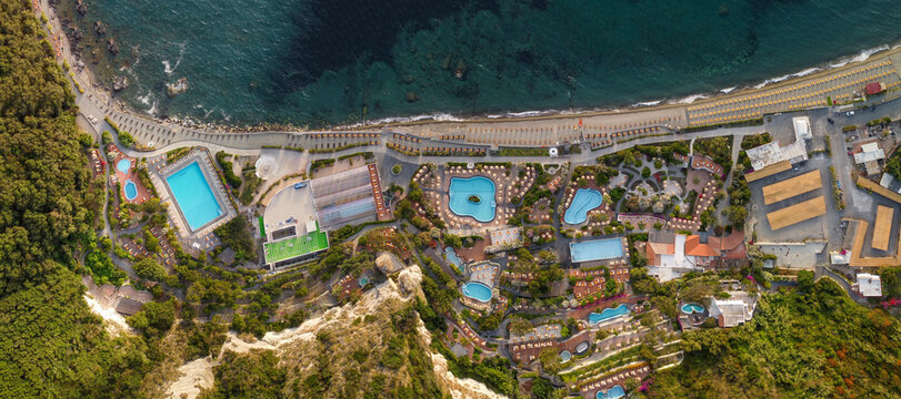 Overhead Aerial View Of Ischia Citara Beach At Sunset With Pools And Sand.