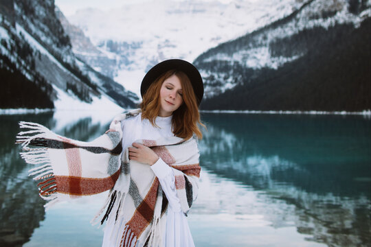 Woman standing near lake in winter