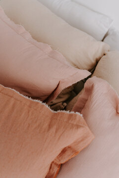 Row of soft cushions on bed