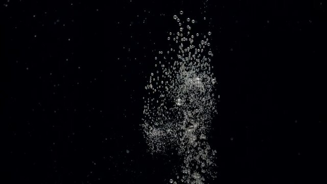 Slow motion air bubbles floating under transparent water bubbles in aquarium. Slowmotion numerous small air bubbles in water rising up to the surface on isolated black background