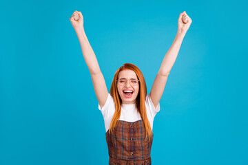 Fototapeta na wymiar Photo of young girl happy positive smile rejoice win victory lucky success fists hands isolated over blue color background