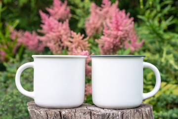 Two Mugs mockup with bokeh green nature. Farmhouse rustic style. White coffee cup mock up. Blank mug printing design template.