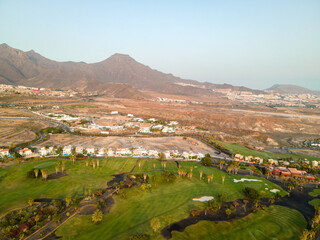 Tenerife, a town on the Atlantic Ocean. Sunny coast and dry soil. Ocean, water, waves, blue ocean.