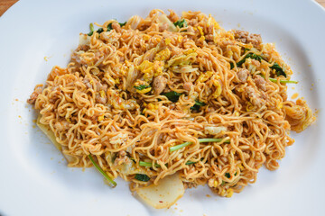 Pad Thai with pork and vegetables in a bowl on the table