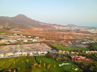 Tenerife, a town on the Atlantic Ocean. Sunny coast and dry soil. Ocean, water, waves, blue ocean.