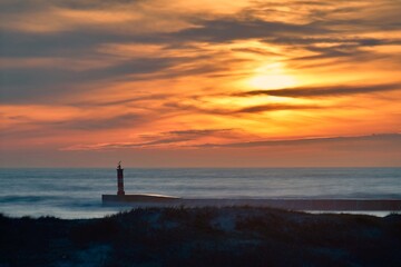 Sunset with lighthouse in the Atlantic Ocean