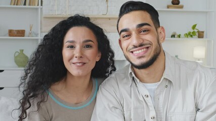 Web cam view portrait close up male and female face online conversation spanish man curly ethnic woman spaniard hispanic married couple indoors remote video call chat talking smiling waving goodbye