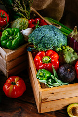 Top view of colorful fresh farm vegetables on a wooden table, balanced diet