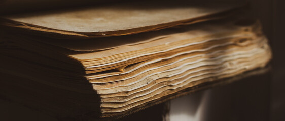 Pages of old weathered book, close up. Education concept. History concept. Aged book in sunlight....