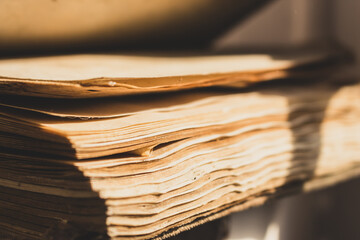 Pages of old weathered book, close up. Education concept. History concept. Aged book in sunlight. Wisdom and knowledge concept. Vintage book in archive. School background. Retro literature. The past.