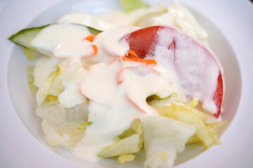 Fototapeta na wymiar Gemischter Salat mit Dressing https://stock.adobe.com/de/contributor/64369/ebraxas