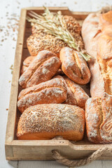 Rustic baguettes and buns baked in bakery. Made of wheat.