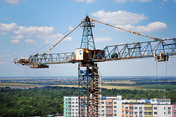 Crane and building against blue sky