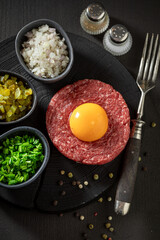 Raw beef tartare with pepper and oil. Tatars traditional dish.