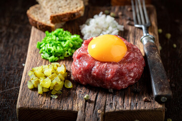 Tasty beef tartare with pepper and oil. Tatars traditional dish.