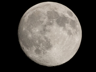 Full moon in the dark night sky. Waxing Crescent