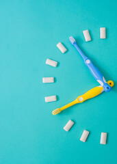 Watches of toothbrushes and chewing gums. Dental care concept.