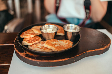 Vegan crispy potato pancakes on a plate in street cafe. Traditional delicious food
