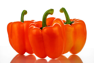 Three ripe sweet peppers, close-up, isolated on white.