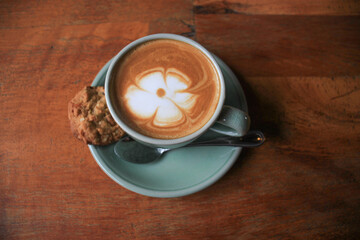 Latte arts coffe hot coffee on wooden table.barista flower art concept.