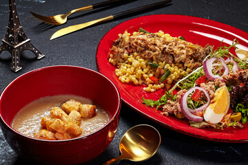Set lunch of mushroom cream soup, ptitim with julienne and Nicoise salad