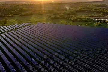 Fototapeta premium Ecology solar power station panels in the fields green energy at sunset landscape electrical innovation nature environment