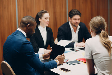Businessman and businesswoman team at office meeting. Business people group conference discussion sit at table with boss man and woman